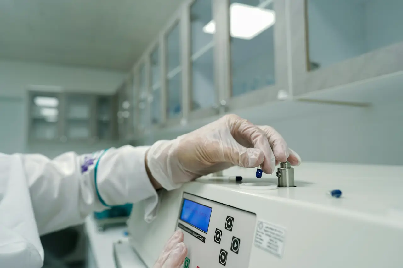 Laboratory worker in gloves using testing equipment