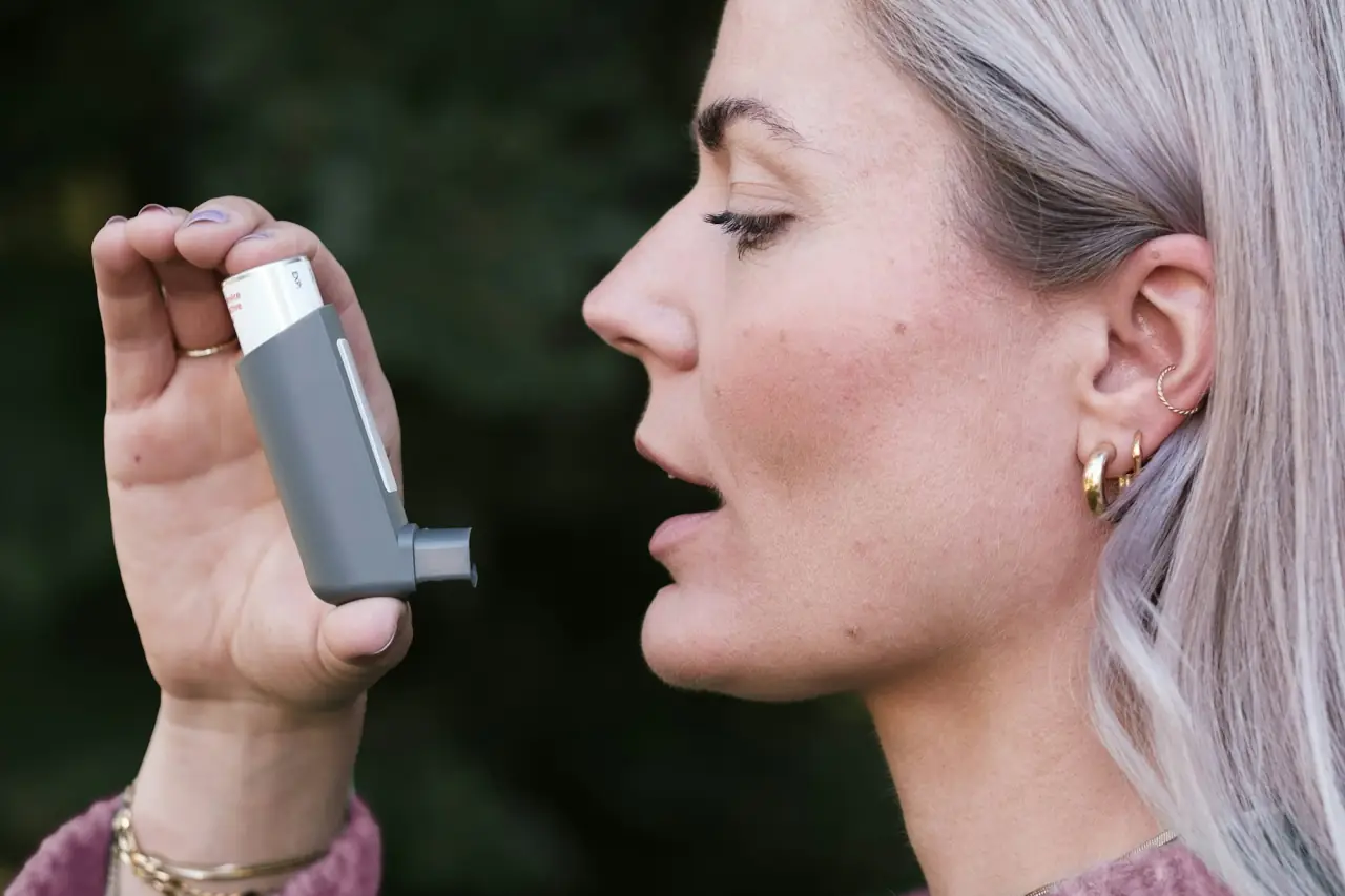 Woman about to use an asthma inhaler